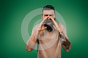 Handsome bearded man screaming isolated