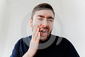 Handsome bearded man suffering from toothache, closeup,