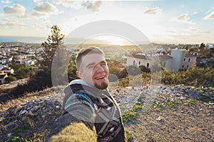 Handsome bearded man taking selfie. Happy student makes funny picture for his blog.