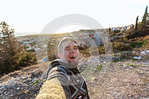 Handsome bearded man taking selfie. Happy student makes funny picture for his blog.