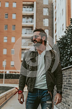 Handsome, bearded man walking alone in teh city
