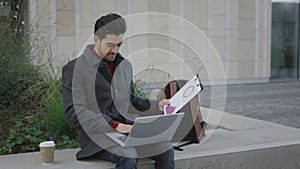 Handsome Bearded Multiethnic Man Sitting Working On Laptop Outside. Foreigh Student Studying In the Street Using