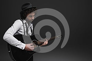 handsome bearded musician playing acoustic guitar