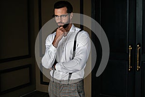 handsome bearded pensive man in white shirt