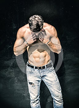 Handsome bearded shirtless young man standing photo