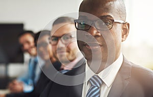 Handsome black business man with three employees