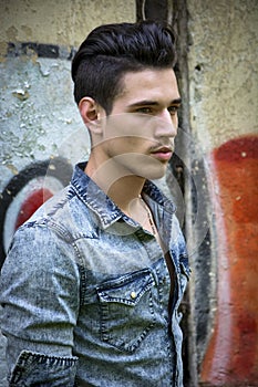 Handsome black haired young man in denim shirt