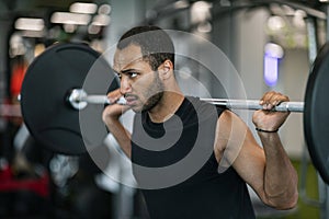 Handsome Black Male Bodybuilder Doing Weight Lifting Workout At Gym