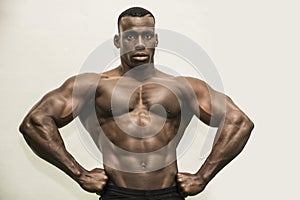 Handsome black male bodybuilder posing in studio