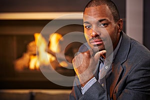 Handsome black man by fireplace