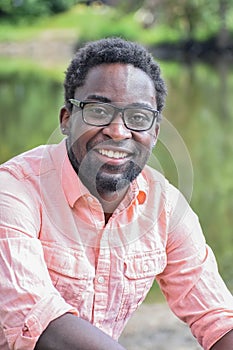 Handsome Black Man with Glasses Posing by River