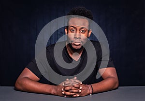 Handsome Black Man seated at table