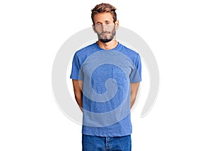 Handsome blond man with beard wearing casual clothes with serious expression on face