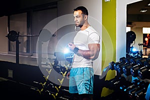 Handsome bodybuilder man in gym listen to music