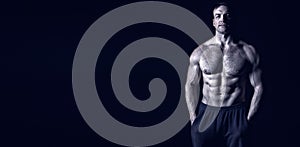 Handsome bodybuilder man with muscular body training in gym