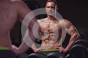 Handsome bodybuilder posing in gym