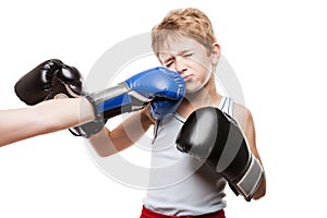 Handsome boxer child boy training boxing sport got punched