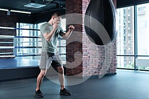 Handsome boxer wearing sport suit and sneakers