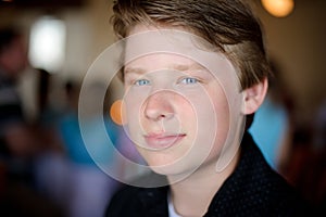 Handsome boy with blond hair and blue eyes in great light.