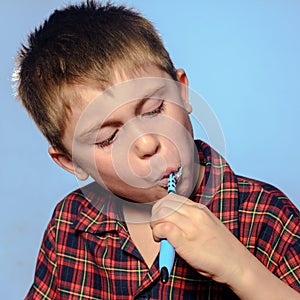 Handsome boy brushing teeth, daily procedure, baby in pajamas, dental care