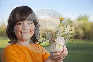 Handsome boy with dandelion flower summer outdoors