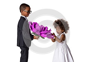 Handsome boy gives a cute girl big origami flower.Kids love.Isolated