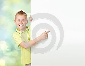 Handsome boy pointing to advertisement banner