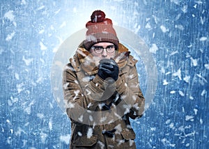 Handsome boy shivering at snowstorm concept