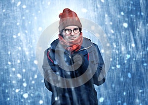 Handsome boy shivering at snowstorm concept