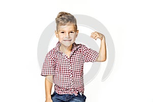 Handsome boy shows his strength on white background