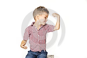 Handsome boy shows his strength on white background