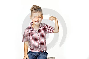 Handsome boy shows his strength on white background