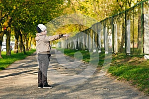 Handsome boy of six years playing, jumping, running, smiling in the park. Place for text