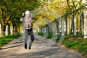 Handsome boy of six years playing, jumping, running, smiling in the park. Place for text