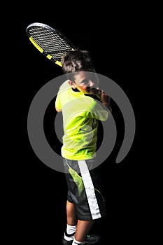 Handsome boy with tennis equipment playing backhand