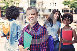 Handsome brazilian male student with group of students