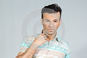 Handsome brazilian male wears colorful summer shirt. 30s.