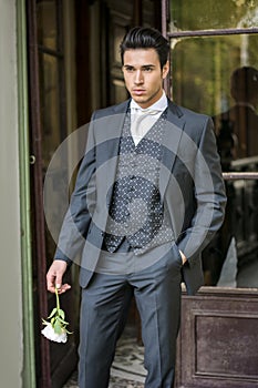 Handsome bridegroom in grey suit