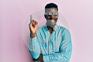 Handsome business black man wearing stylish sunglasses smiling happy pointing with hand and finger to the side