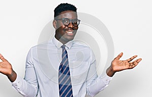 Handsome business black man wearing white shirt and tie celebrating victory with happy smile and winner expression with raised