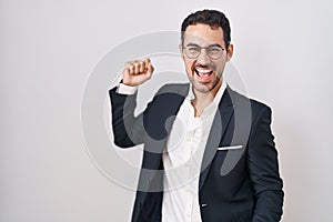 Handsome business hispanic man standing over white background dancing happy and cheerful, smiling moving casual and confident