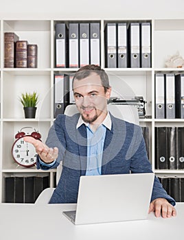 Handsome business man boss with welcome gesture in office