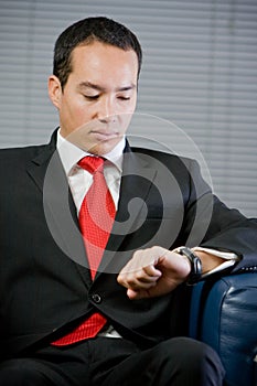 Handsome business man looking at his watch