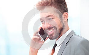 Handsome Business man in an office using smartphone