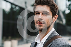 Handsome business man outdoors looking at the camera