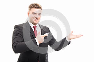 Handsome business man pointing copyspace area