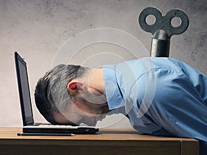 Business man sleeping on laptop