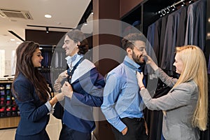 Handsome Business Man Trying Clothes Woman Fashion Shop, Customers Choosing In Retail Store