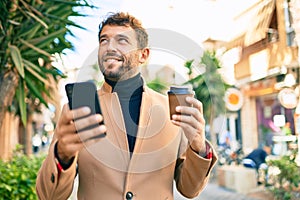 Handsome business man wearing elegant jacket using smartphone smiling happy outdoors