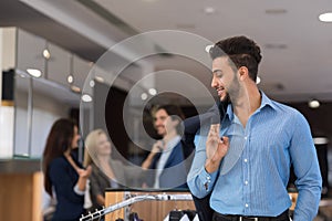 Handsome Business Man And Woman Fashion Shop, Customers Choosing Clothes In Retail Store